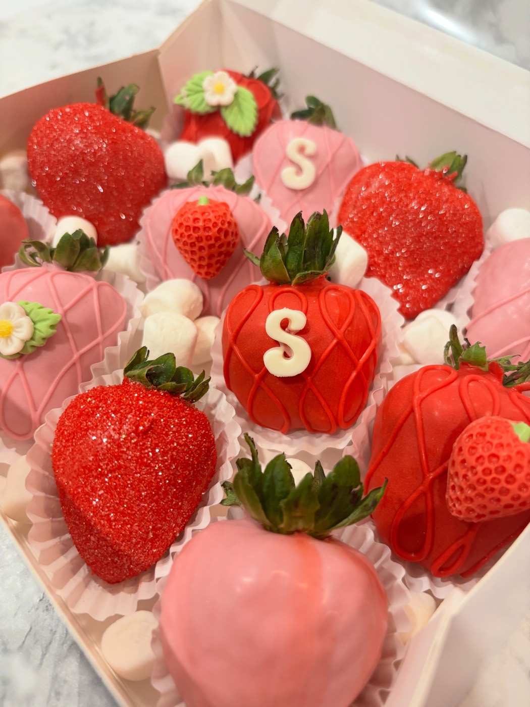 Red and pink strawberries with an S monogram